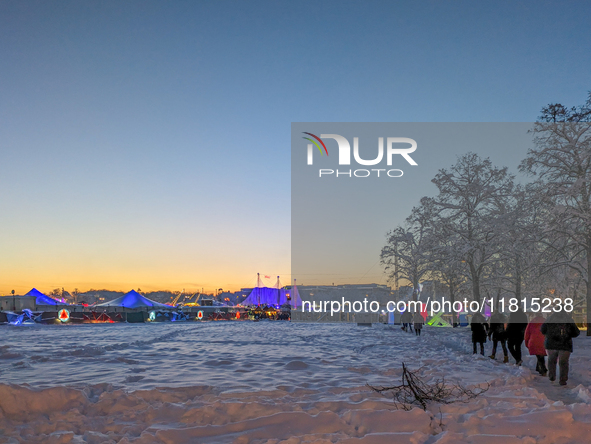 A snow-covered scene at the Winter Tollwood Festival on December 3, 2023, in Munich, Germany, shows the event's focus on art, culture, and s...