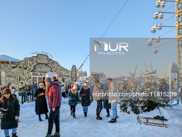 A snow-covered scene at the Winter Tollwood Festival on December 3, 2023, in Munich, Germany, shows the event's focus on art, culture, and s...