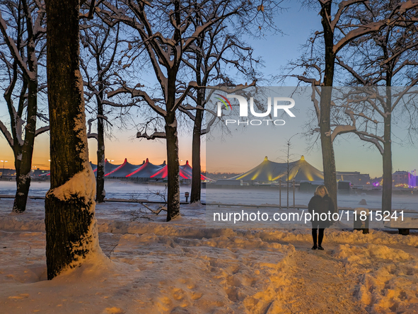 A snow-covered scene at the Winter Tollwood Festival on December 3, 2023, in Munich, Germany, shows the event's focus on art, culture, and s...