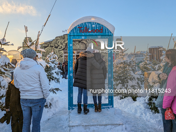 A snow-covered scene at the Winter Tollwood Festival on December 3, 2023, in Munich, Germany, shows the event's focus on art, culture, and s...