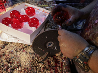 Craftsmen cut handcrafted balls made of blown glass for sale in the Tlahuac municipality, Mexico City, on Christmas Eve and New Year in Mexi...