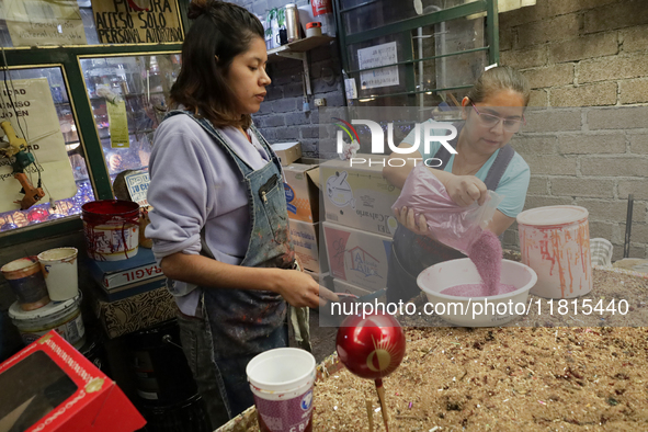 Handcrafted balls made of blown glass are decorated for sale in the Tlahuac municipality, Mexico City, on Christmas Eve and New Year in Mexi...