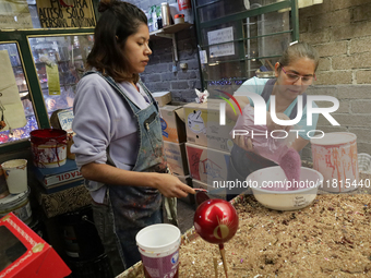 Handcrafted balls made of blown glass are decorated for sale in the Tlahuac municipality, Mexico City, on Christmas Eve and New Year in Mexi...