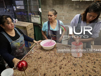 Handcrafted balls made of blown glass are decorated for sale in the Tlahuac municipality, Mexico City, on Christmas Eve and New Year in Mexi...