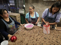 Handcrafted balls made of blown glass are decorated for sale in the Tlahuac municipality, Mexico City, on Christmas Eve and New Year in Mexi...