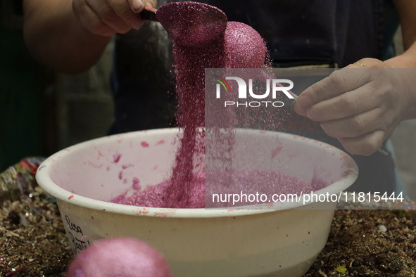 Handcrafted balls made of blown glass are decorated for sale in the Tlahuac municipality, Mexico City, on Christmas Eve and New Year in Mexi...