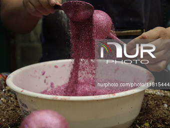 Handcrafted balls made of blown glass are decorated for sale in the Tlahuac municipality, Mexico City, on Christmas Eve and New Year in Mexi...