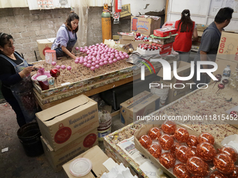 Inside a workshop and cooperative in the Tlahuac municipality, Mexico City, artisans make spheres from blown glass for sale on Christmas and...