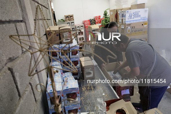 Inside a workshop and cooperative in the Tlahuac municipality, Mexico City, artisans make spheres from blown glass for sale on Christmas and...