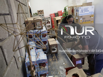 Inside a workshop and cooperative in the Tlahuac municipality, Mexico City, artisans make spheres from blown glass for sale on Christmas and...