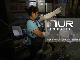 Josefina Aguilar, an industrial biochemist, puts on bandages before making handcrafted balls made of blown glass for sale in the Tlahuac mun...