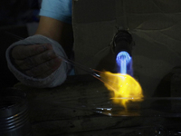 Josefina Aguilar, an industrial biochemist, makes handcrafted balls made of blown glass for sale in the Tlahuac municipality, Mexico City, o...