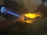 Josefina Aguilar, an industrial biochemist, makes handcrafted balls made of blown glass for sale in the Tlahuac municipality, Mexico City, o...