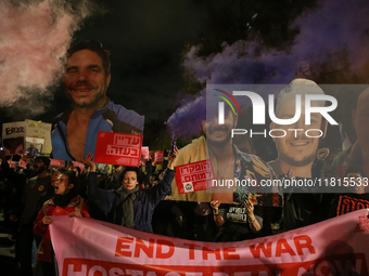 People attend a protest march in support of the hostages kidnapped during the deadly October 7, 2023, attack by Hamas, marking a year since...