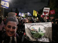 People attend a protest march in support of the hostages kidnapped during the deadly October 7, 2023, attack by Hamas, marking a year since...