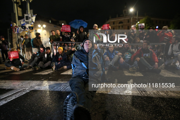 People block a road during a protest in support of the hostages kidnapped during the deadly October 7, 2023, attack by Hamas, marking a year...