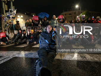 People block a road during a protest in support of the hostages kidnapped during the deadly October 7, 2023, attack by Hamas, marking a year...