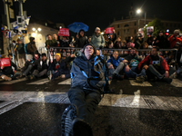 People block a road during a protest in support of the hostages kidnapped during the deadly October 7, 2023, attack by Hamas, marking a year...