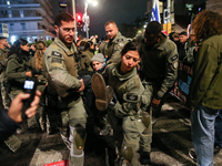 Police officers drag demonstrators as people block a road during a protest in support of the hostages kidnapped during the deadly October 7,...