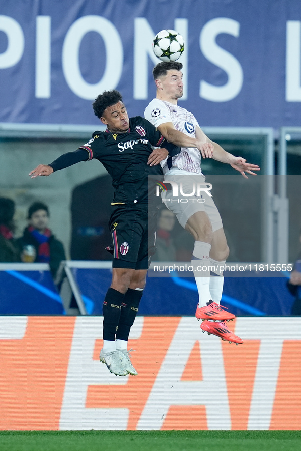 Dan Ndoye of Bologna FC and Thomas Meunier of LOSC Lille jump for the ball during the UEFA Champions League 2024/25 League Phase MD5 match b...