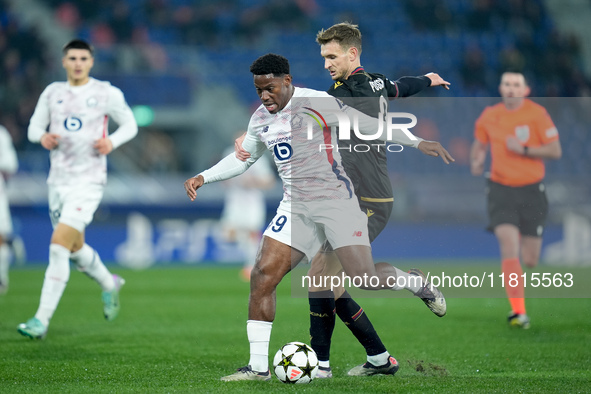 Jonathan David of LOSC Lille and Stefan Posch of Bologna FC during the UEFA Champions League 2024/25 League Phase MD5 match between Bologna...