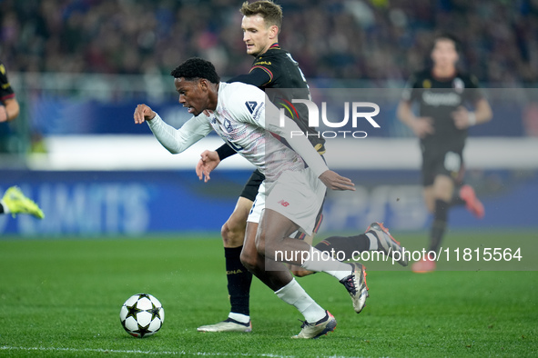 Jonathan David of LOSC Lille and Stefan Posch of Bologna FC compete for the ball during the UEFA Champions League 2024/25 League Phase MD5 m...