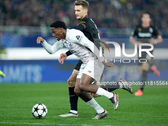 Jonathan David of LOSC Lille and Stefan Posch of Bologna FC compete for the ball during the UEFA Champions League 2024/25 League Phase MD5 m...