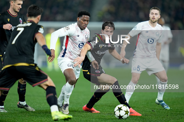 Jonathan David of LOSC Lille and Giovanni Fabbian of Bologna FC compete for the ball during the UEFA Champions League 2024/25 League Phase M...