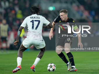 Ngal'ayel Mukau of LOSC Lille and Lewis Ferguson of Bologna FC compete for the ball during the UEFA Champions League 2024/25 League Phase MD...