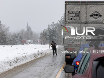 A winter storm brings chain control and delays on Interstate 80 East near Cisco Grove, Calif., on November 27, 2024. (