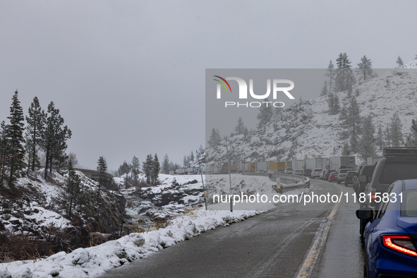 A winter storm brings chain control and delays on Interstate 80 East near Cisco Grove, California, on November 26, 2024. 