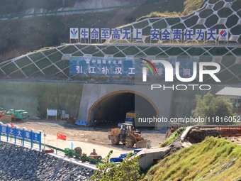 Workers work at the Longtanxi water intake site of the South-to-North Water Diversion project in the Three Gorges Reservoir area of Yichang,...