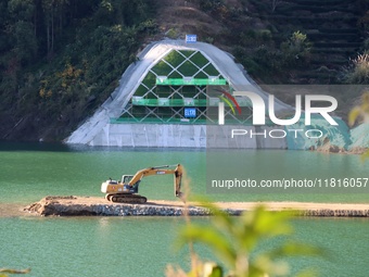 Workers work at the Longtanxi water intake site of the South-to-North Water Diversion project in the Three Gorges Reservoir area of Yichang,...