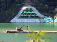 Workers work at the Longtanxi water intake site of the South-to-North Water Diversion project in the Three Gorges Reservoir area of Yichang,...