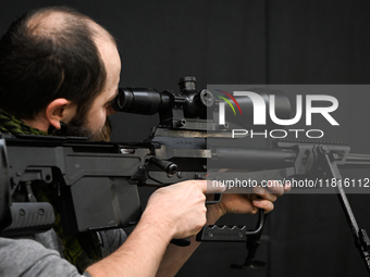 KRAKOW, POLAND - NOVEMBER 27:   
A participant tests the 12.7 ZMT WKW 50 large-caliber sniper rifle, produced by PGZ Zaklady Mechaniczne Tar...