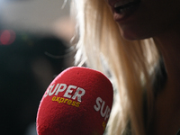 KRAKOW, POLAND - NOVEMBER 27:   
A Super Express microphone held by a reporter during an interview with Bronislaw Komorowski, former Preside...