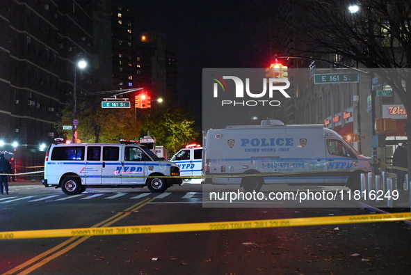 Crime scene investigators with the NYPD mark evidence at the scene and a vehicle with bullet holes where a 29-year-old man is shot in the ch...