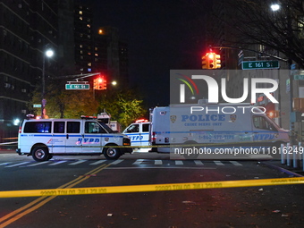 Crime scene investigators with the NYPD mark evidence at the scene and a vehicle with bullet holes where a 29-year-old man is shot in the ch...