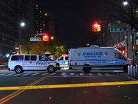 Crime scene investigators with the NYPD mark evidence at the scene and a vehicle with bullet holes where a 29-year-old man is shot in the ch...