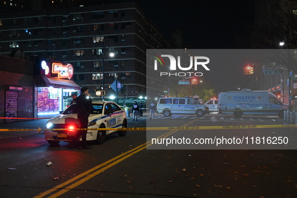 Crime scene investigators with the NYPD mark evidence at the scene and a vehicle with bullet holes where a 29-year-old man is shot in the ch...