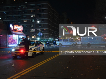 Crime scene investigators with the NYPD mark evidence at the scene and a vehicle with bullet holes where a 29-year-old man is shot in the ch...