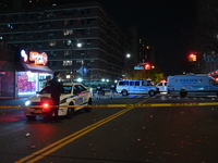 Crime scene investigators with the NYPD mark evidence at the scene and a vehicle with bullet holes where a 29-year-old man is shot in the ch...