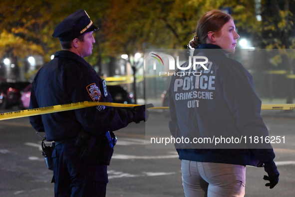 Crime scene investigators with the NYPD mark evidence at the scene and a vehicle with bullet holes where a 29-year-old man is shot in the ch...