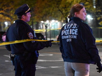 Crime scene investigators with the NYPD mark evidence at the scene and a vehicle with bullet holes where a 29-year-old man is shot in the ch...