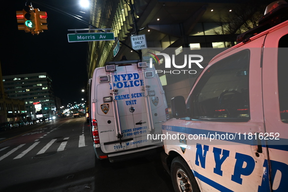 Crime scene investigators with the NYPD mark evidence at the scene and a vehicle with bullet holes where a 29-year-old man is shot in the ch...