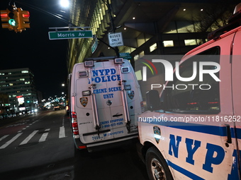 Crime scene investigators with the NYPD mark evidence at the scene and a vehicle with bullet holes where a 29-year-old man is shot in the ch...