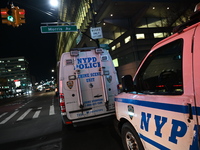 Crime scene investigators with the NYPD mark evidence at the scene and a vehicle with bullet holes where a 29-year-old man is shot in the ch...