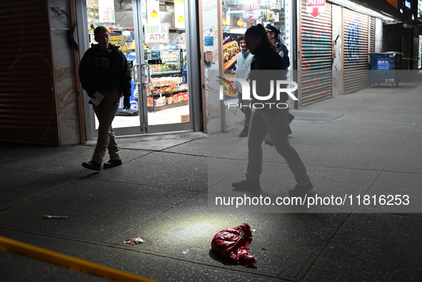 Crime scene investigators with the NYPD mark evidence at the scene and a vehicle with bullet holes where a 29-year-old man is shot in the ch...