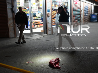 Crime scene investigators with the NYPD mark evidence at the scene and a vehicle with bullet holes where a 29-year-old man is shot in the ch...