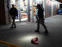 Crime scene investigators with the NYPD mark evidence at the scene and a vehicle with bullet holes where a 29-year-old man is shot in the ch...